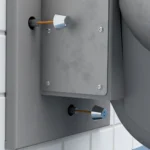 A front mounted toilet fixture being bolted to the wall.