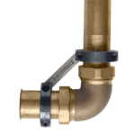 A Metcraft Flush Valve Stabilizer installed on a pipe fitting.