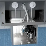 The opened rear cavity of a front mounted lavatory fixture.